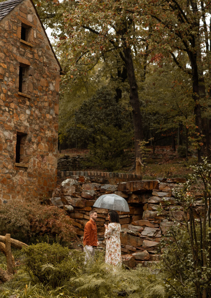 couple standing in the rain under umbrella