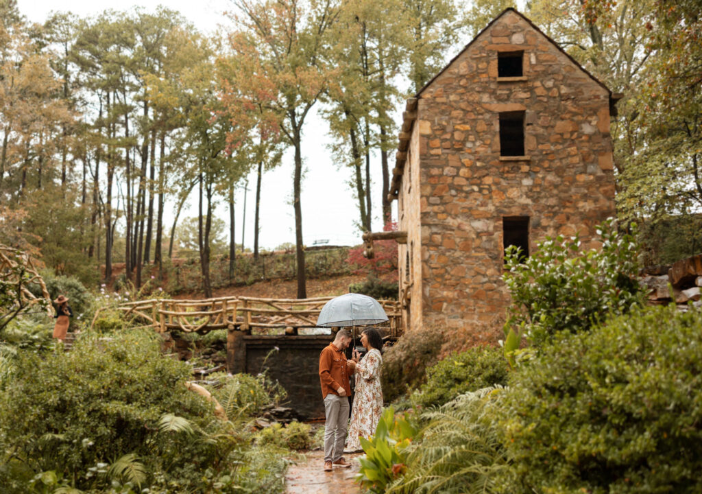 couple standing in the rain under umbrella