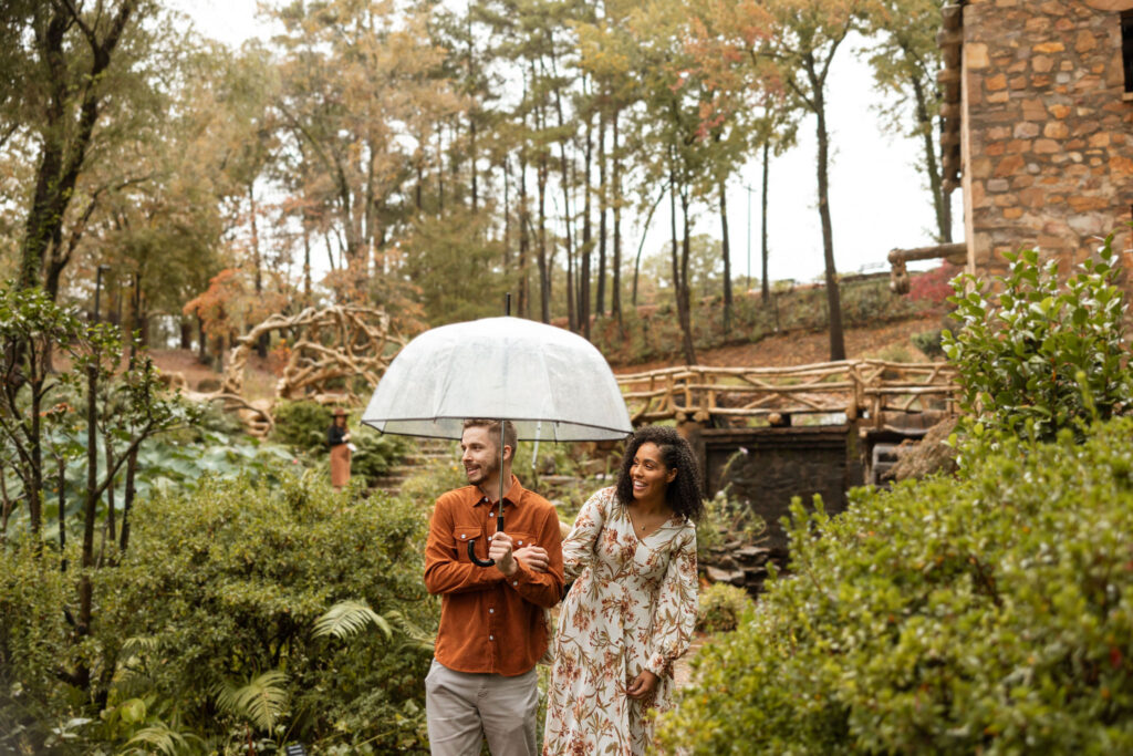 couple holding hands and walking in the rain