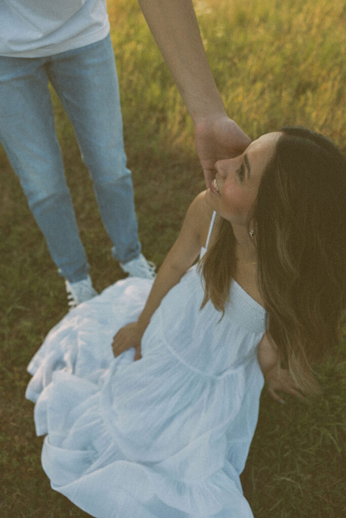 hazy editing arkansas engagement photos in a field