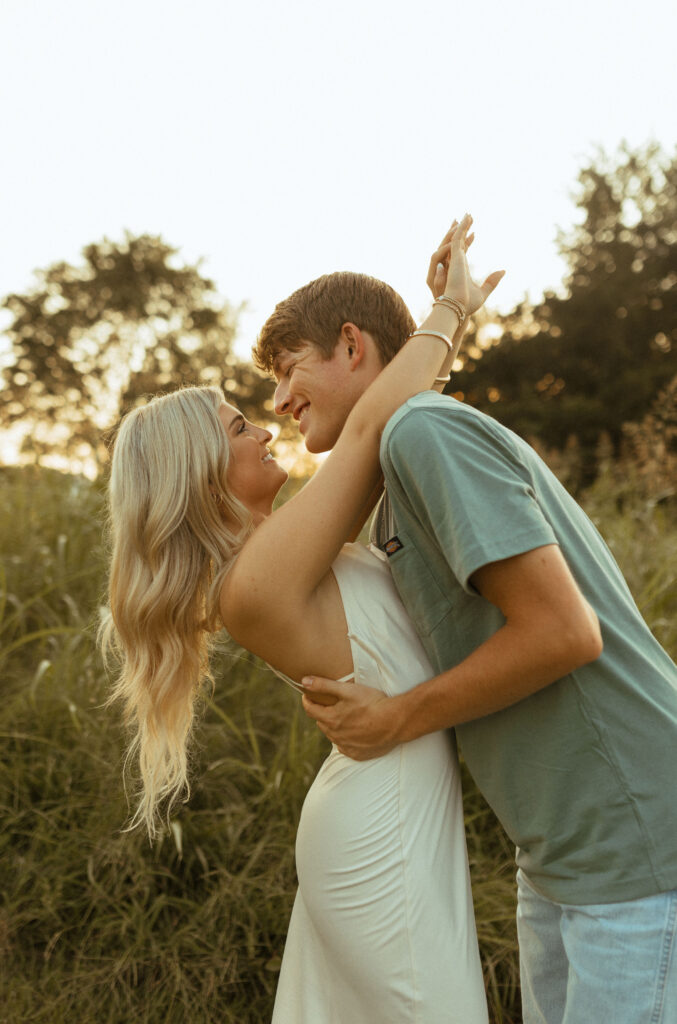 engagement photos in northwest arkansas in a field