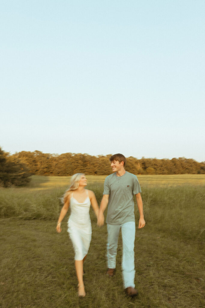 field sunset engagement photos poses running
