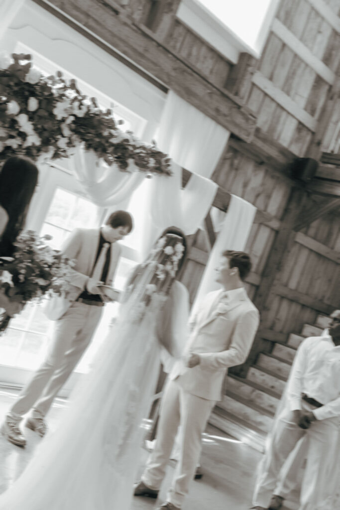 bride and groom holding hands during wedding ceremony