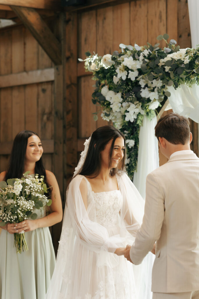 bride and groom holding hands during wedding ceremony