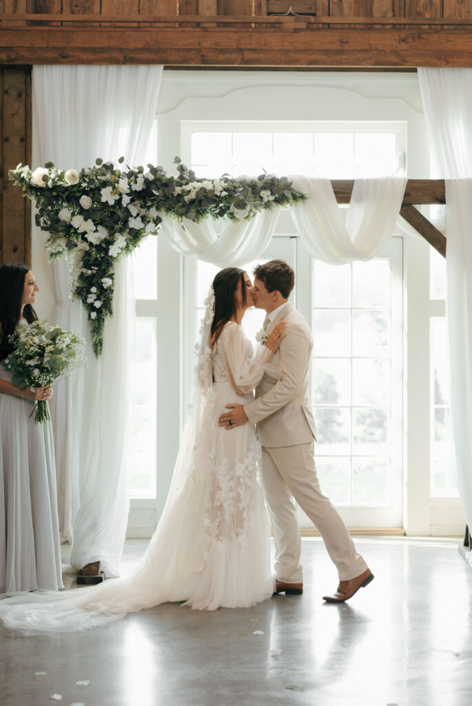 bride and groom celebrating first kiss at wedding ceremony