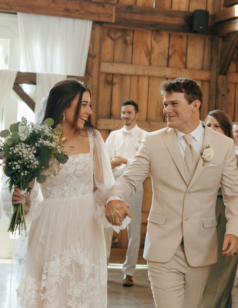 bride and groom celebrating first kiss at wedding ceremony