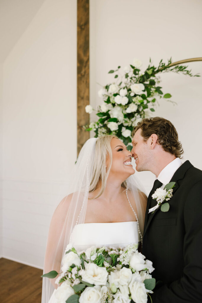 bridal portraits with bride and groom wedding arch with flowers