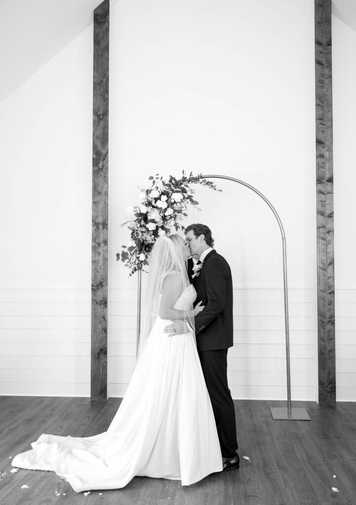 bridal portraits with bride and groom wedding arch with flowers