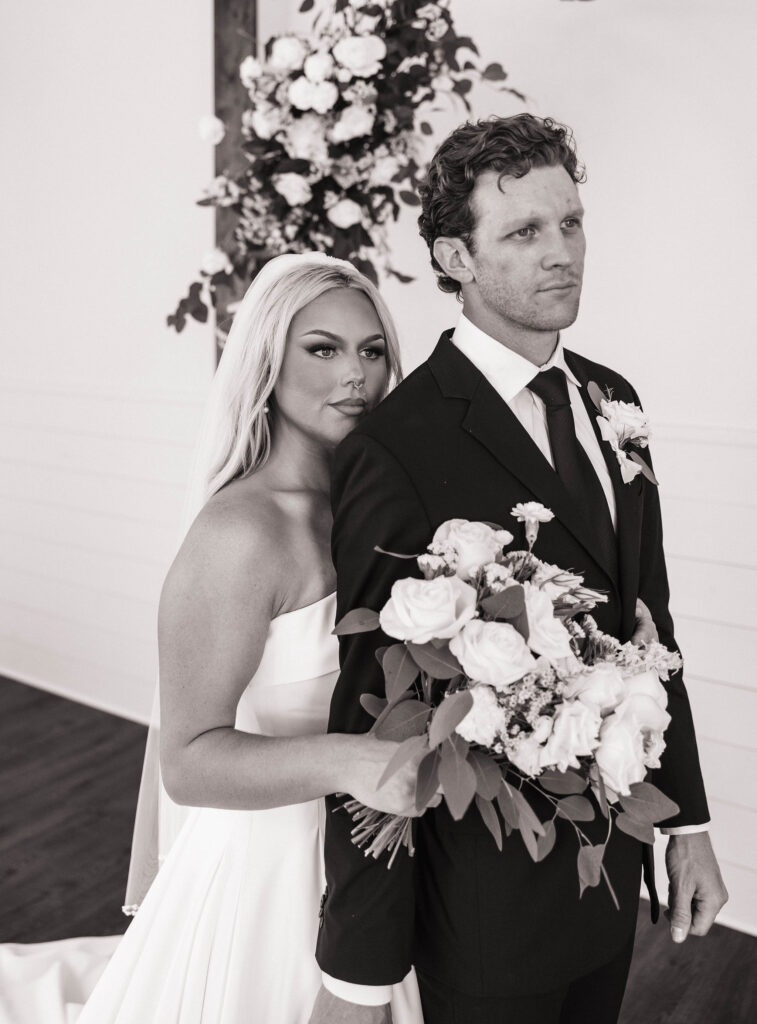 bridal portraits with bride and groom wedding arch with flowers