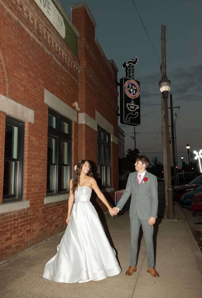 flash wedding photos in front of onyx coffee lab