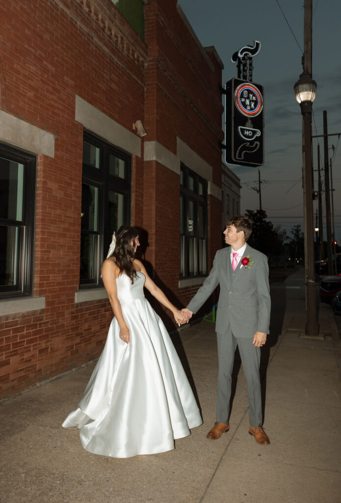 flash wedding photos in front of onyx coffee lab