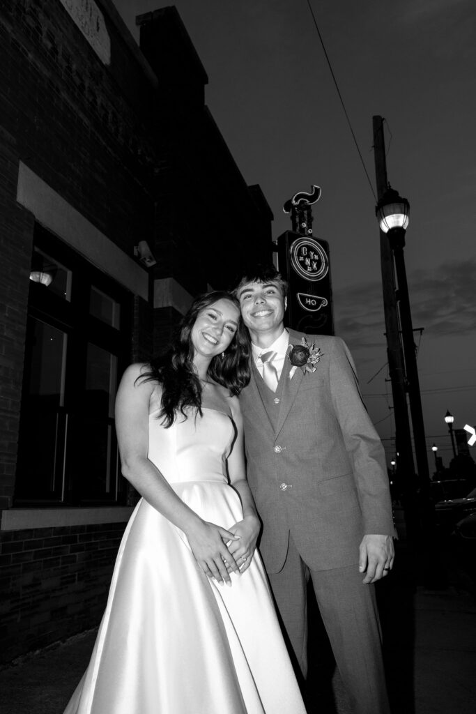 flash wedding photos in front of onyx coffee lab
