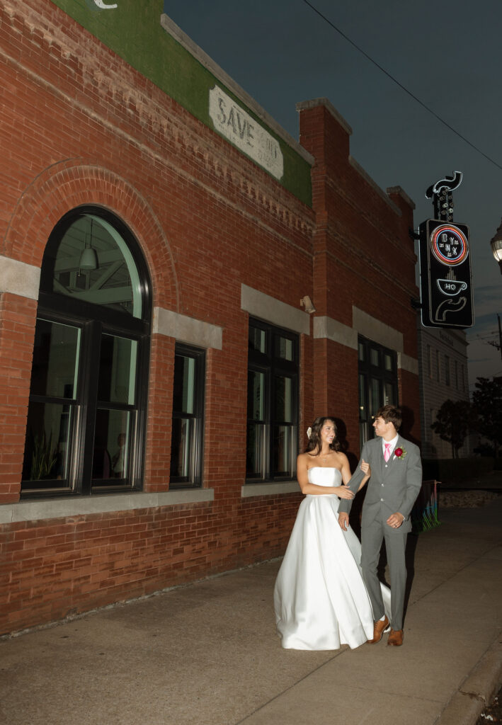 flash wedding photos in front of onyx coffee lab
